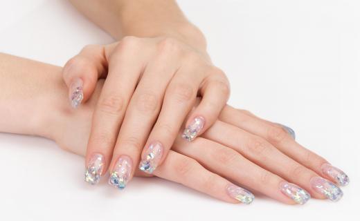 A bride with a manicure that complements her dress.
