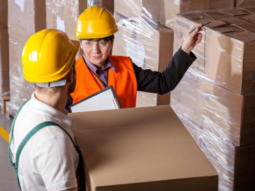 Inventory managers and other employees in a cosmetic warehouse sort and store products for retail distribution.