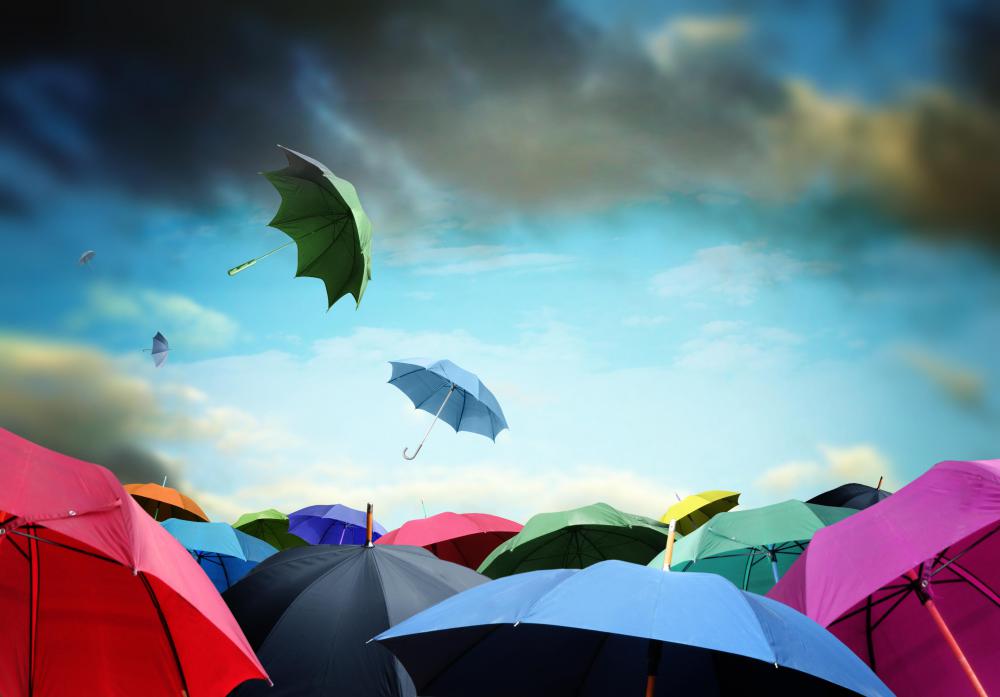 Using an umbrella to block the sun can help avoid serious sunburns.