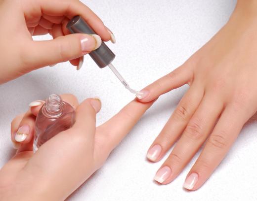 A woman getting a French manicure.