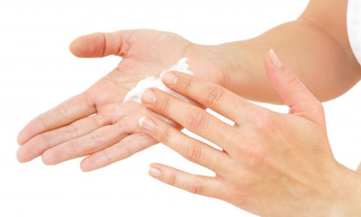 A woman using shea butter hand cream.