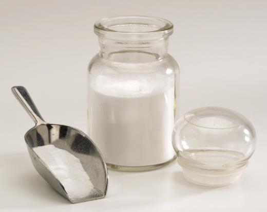 Jar and a scoop with baking soda (sodium bicarbonate).