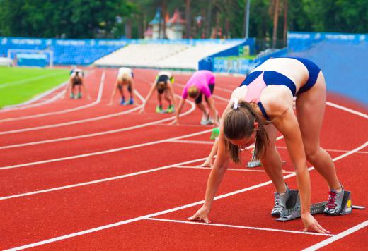 Many runners wear tight uniforms during their heats, but wear tear-away track pants over them before and after races.