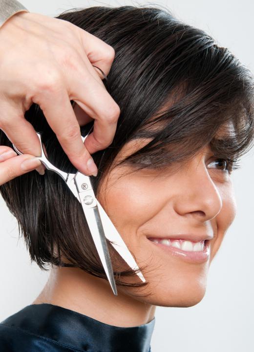 A hairstylist cutting a graduated bob.