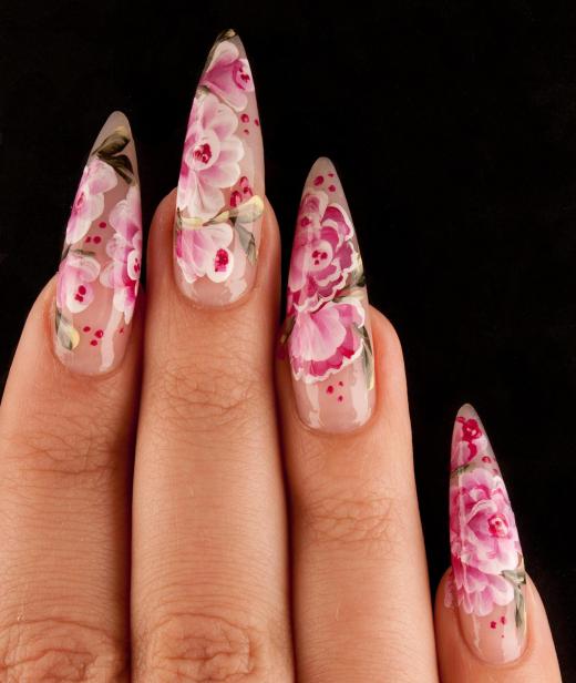 Ornate flower design on artificial fingernails.