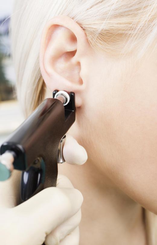 A specially designed gun is used to pierce ears.