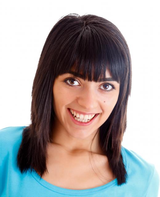 The shape of one's face should be taken into consideration when cutting bangs.