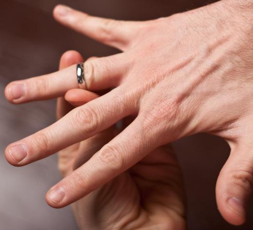 A person putting on a gold ring.