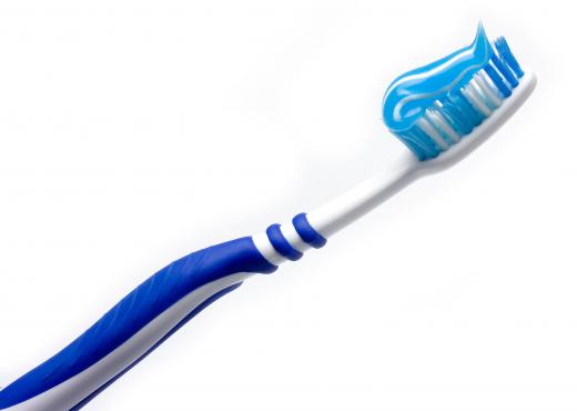 A toothbrush with tooth gel on it.