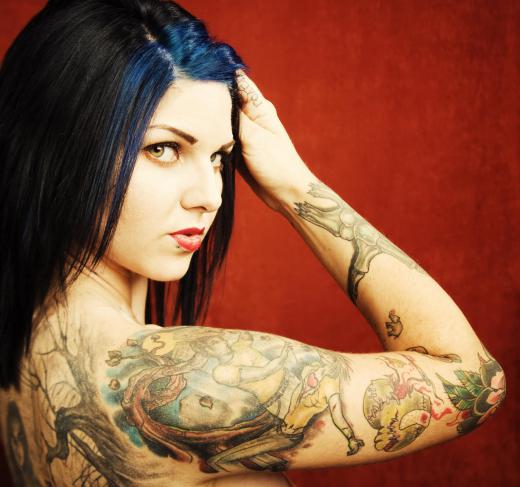 Woman with tattoos on her arm and back.